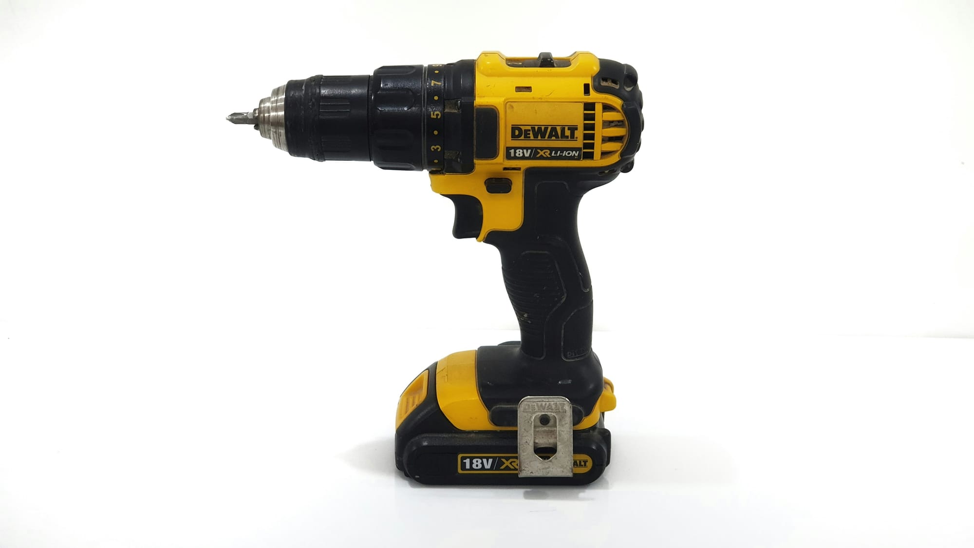 A yellow and black DeWalt drill on a white background